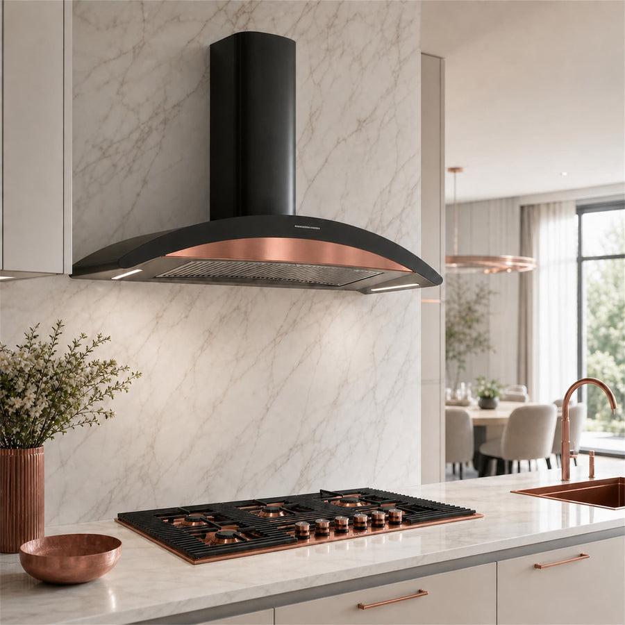 A modern kitchen scene featuring a black range hood with a copper-coloured inner trim