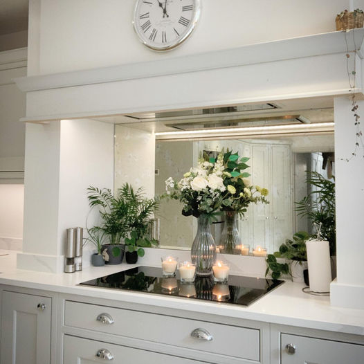 Luxair 72cm stainless steel canopy cooker hood with energy-efficient brushless motor, installed in a white mantel chimney breast with mirrored backsplash.