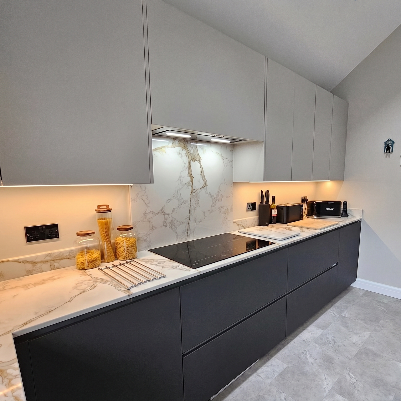 Luxair 72cm stainless steel canopy cooker hood with Dynamic LED lighting installed in a modern grey kitchen with marble backsplash- dynamic LED lighting to match kitchen