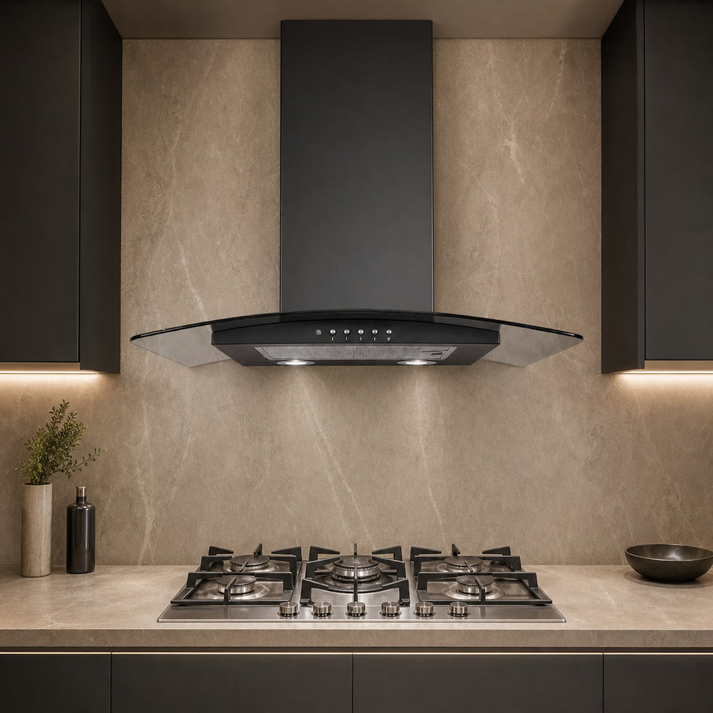 A modern kitchen scene featuring a black glass-front range hood mounted above a stainless steel gas cooktop