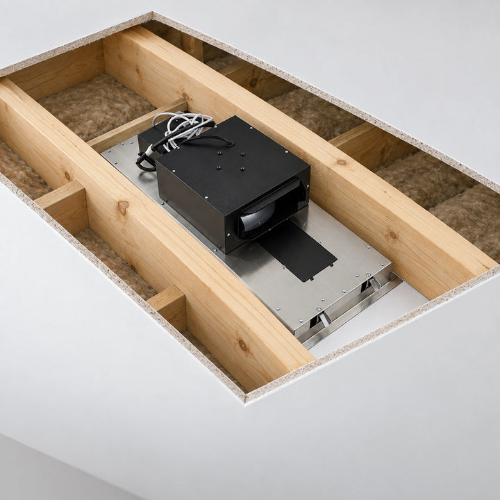 A ceiling-mounted black rectangular device with attached cords and a protruding black strip, installed on a metal track inside a wooden-framed ceiling cavity with insulation visible.
