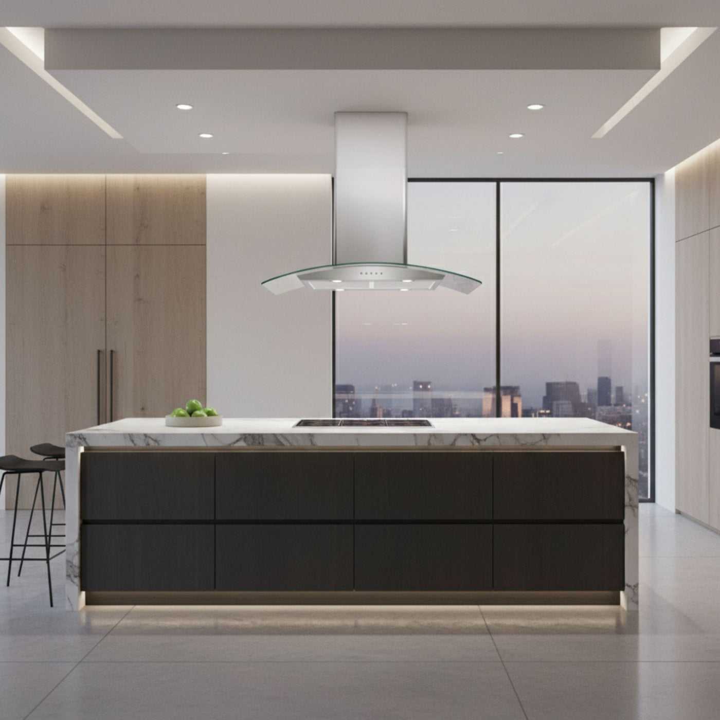 90cm Curved Glass Island cooker hood in a modern kitchen with a large marble island, feature LED lighting and cityscape view