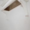 Box sits on top of the corbels and is additionally secured to the wall